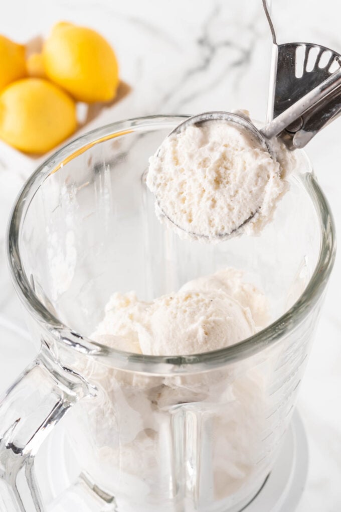 scooping vanilla ice cream in a blender