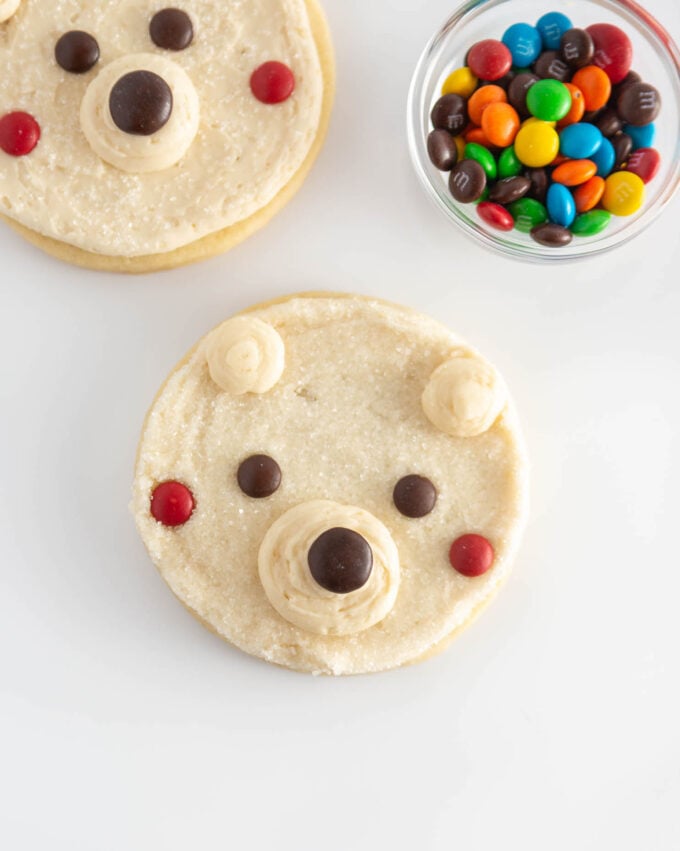 circle polar bear sugar cookie face decorated with M&M's for eyes and cheeks