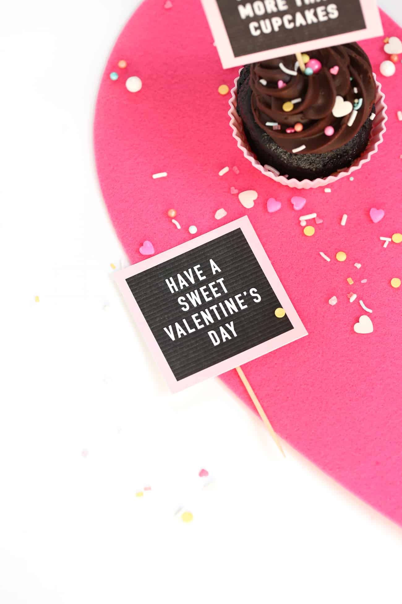 Chocolate cupcakes with Free Printable Valentine Cupcake Toppers - mini pink letterboards! Have a Sweet Valentine's Day and I Love You More Than Cupcakes Phrases