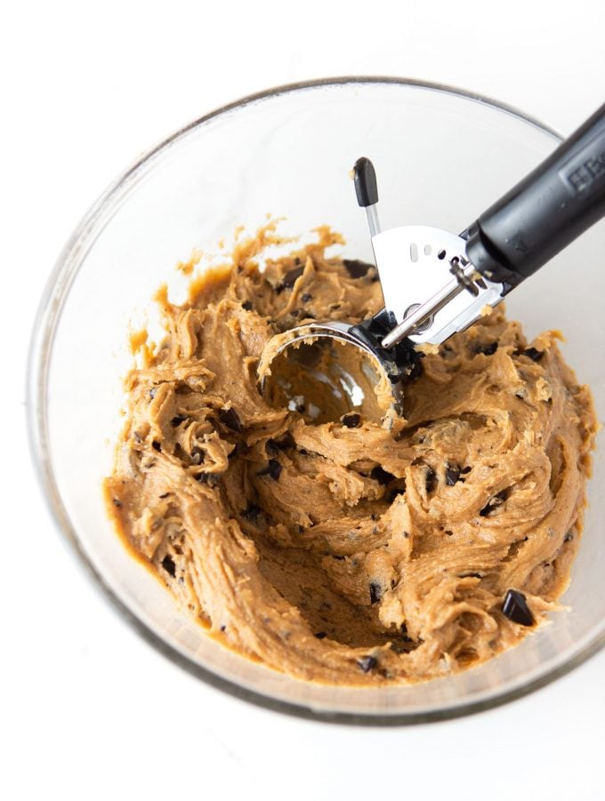 Bowl of peanut butter chocolate chip cookie dough with 3 tablespoon cookie scoop