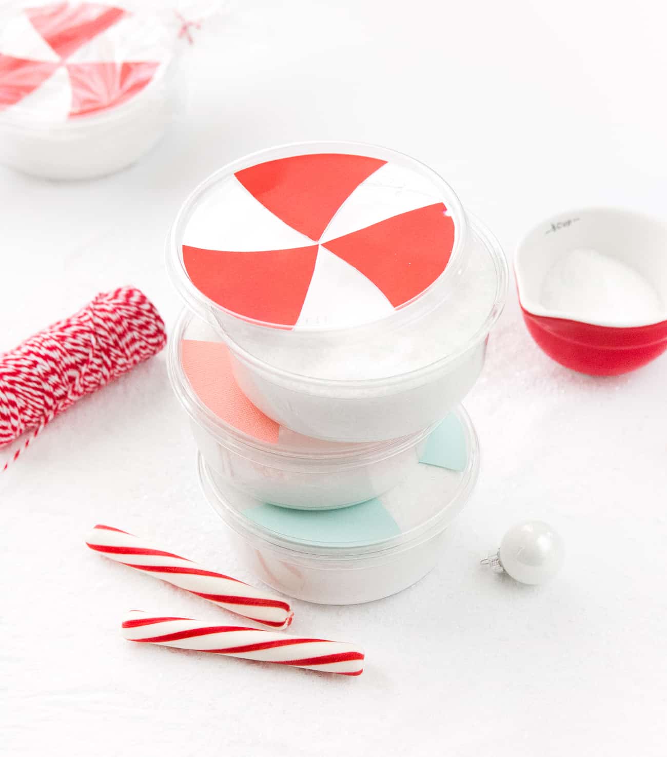 Containers of peppermint DIY bath salt decorated as peppermint candy.