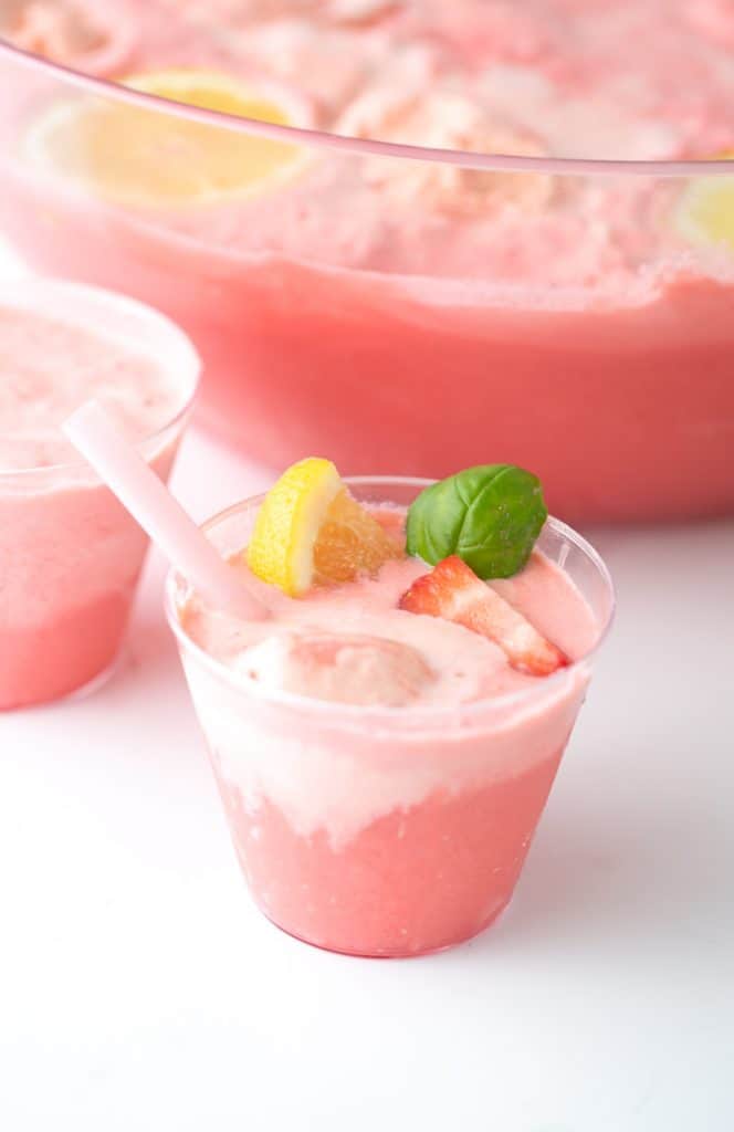 Cup of Pink Strawberry Sherbet Punch with Lemons and Basil