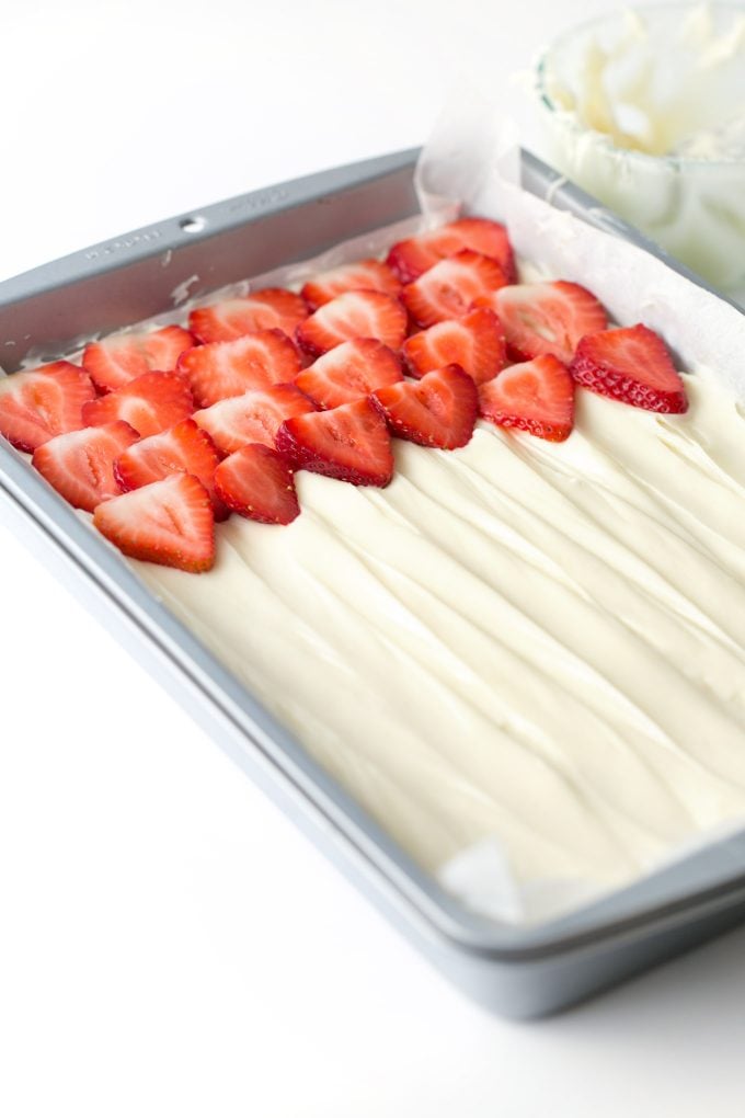 Pan of strawberry fruit pizza with cream cheese frosting