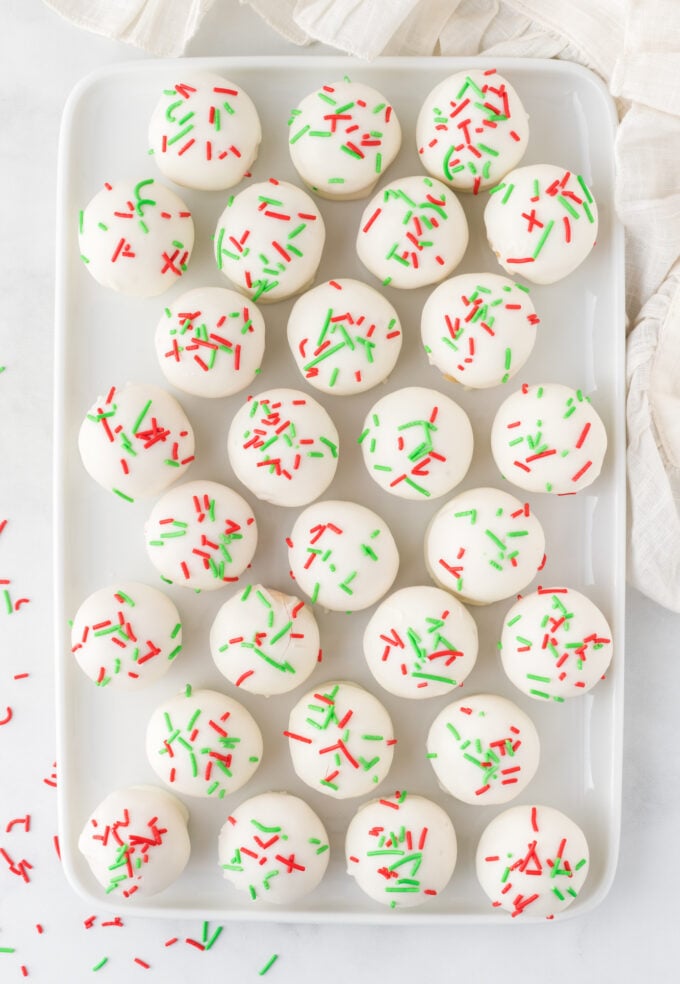tray of white chocolate sugar cookie truffles with red and green sprinkles