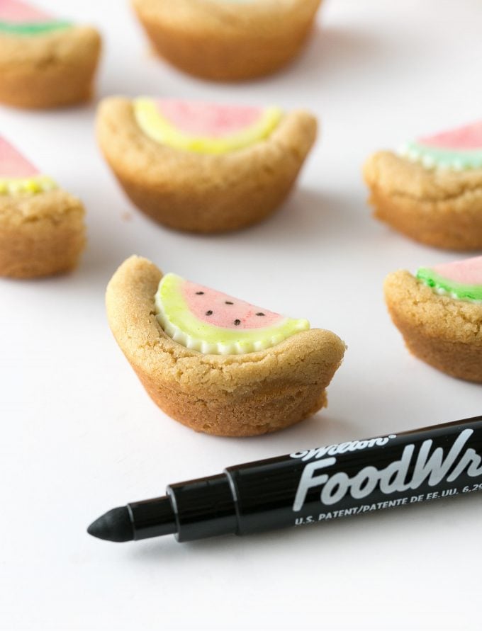 Draw seeds on watermelon cookie cup with black food marker
